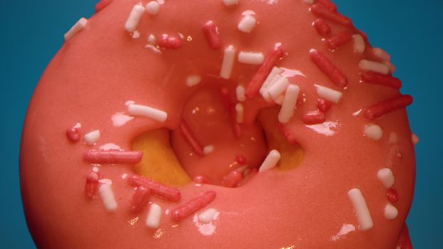 Extreme close up donut on blue background. Tasty snack, dessert