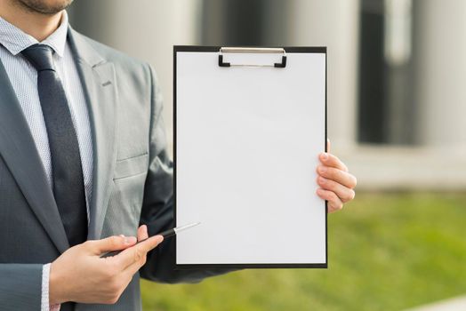 businessman presenting clipboard