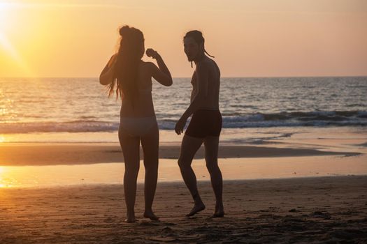 Silhouette of a young couple together at the beach, Goa, India