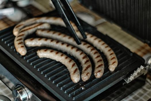 Grilled sausages are cooked, close up shot