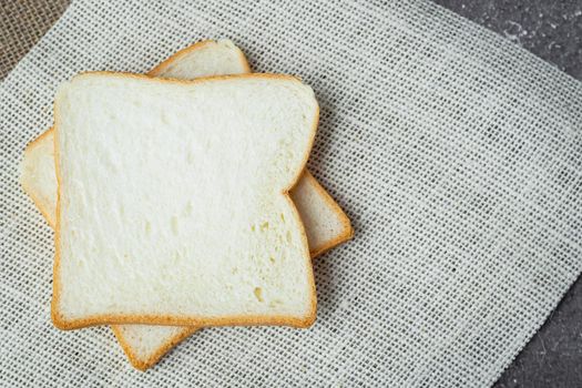 Sliced bread on dark grunge background for bakery, food and eating concept