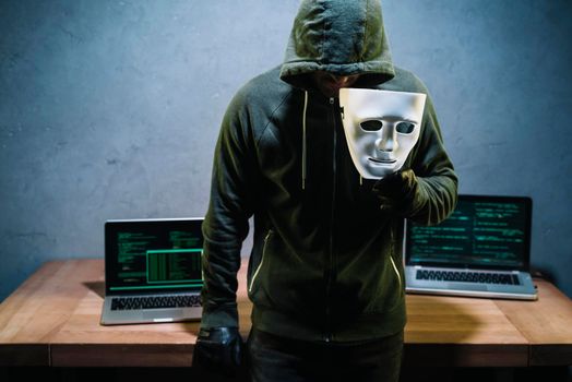 hacker holding mask