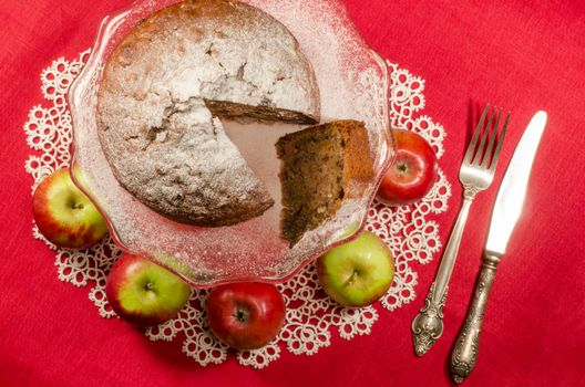 Applesauce raisin rum cake for christmas table. Table decorated with lacy napkin. From series of "Merry Christmas"