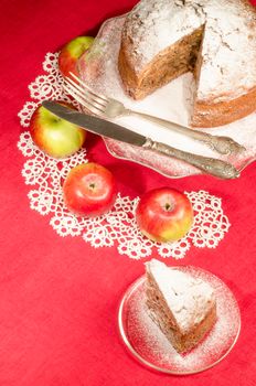 Applesauce raisin rum cake for christmas table. Table decorated with lacy napkin. From series of "Merry Christmas"