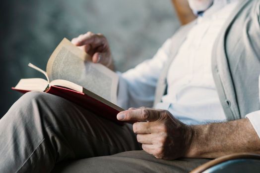 close up man turning pages book