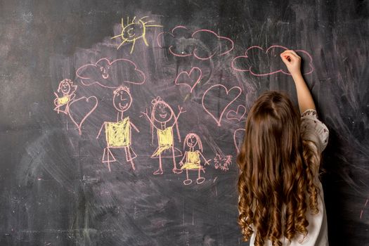 little girl drawing family blackboard