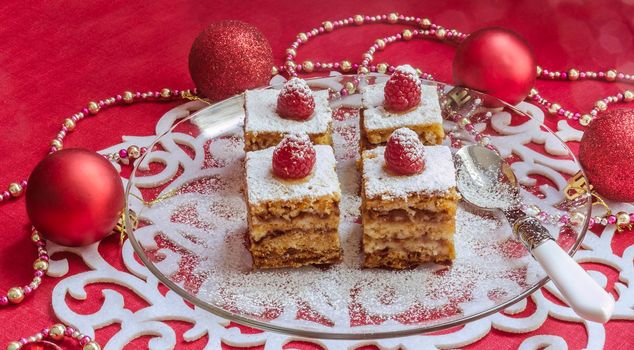 Holiday apple pie bars, garnished with fresh raspberries Near Christmas decorations. From series Winter pastry