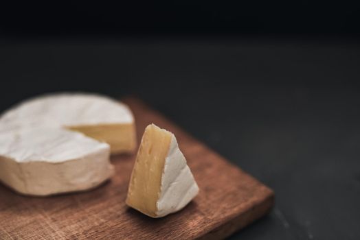 cheese camembert with mold on the wooden cutting board