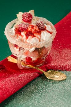 Christmas dessert in a glass with decoration. blurred background. From series "Cranberry-raspberry trifle"