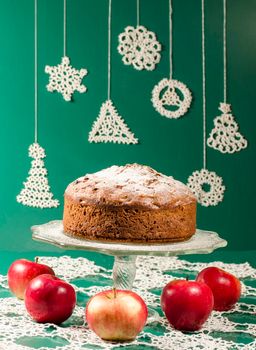 Applesauce raisin rum cake for christmas table. Table decorated with lacy snowflakes and napkin. From series of "Merry Christmas"