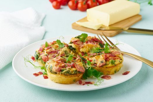 egg muffins with spinach, bacon and tomato, ketogenic keto diet low carb, pastel and modern background closeup