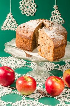 Applesauce raisin rum cake for christmas table. Table decorated with lacy snowflakes and napkin. From series of "Merry Christmas"