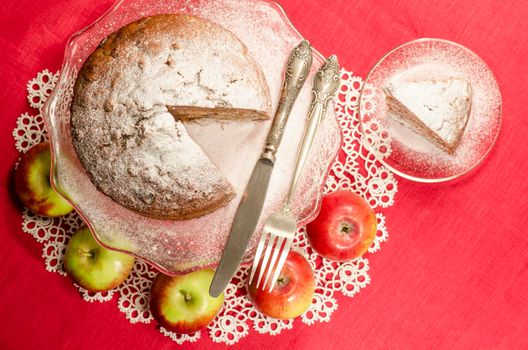 Applesauce raisin rum cake for christmas table, blurred background Table decorated with lacy napkin. From series of "Merry Christmas"