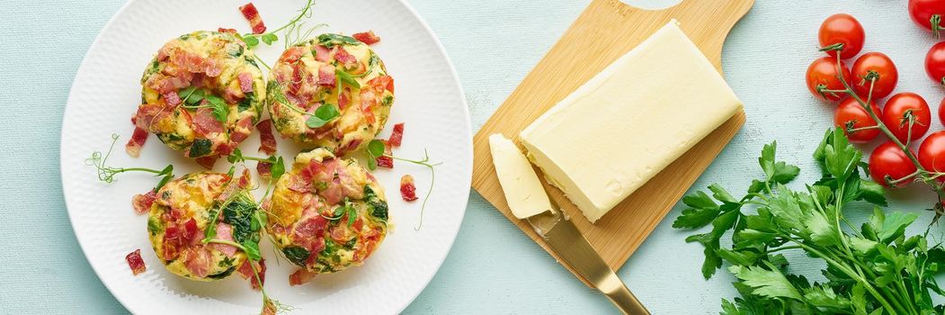 egg muffins with spinach, bacon and tomato, ketogenic keto diet low carb, pastel and modern background top view banner long