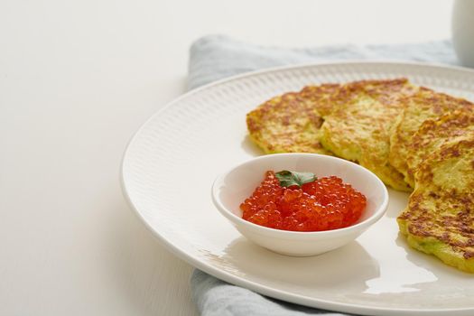 Balanced and gluten free zucchini pancakes with red caviar