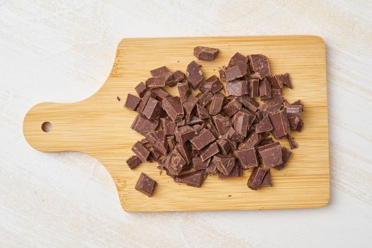 Chopped chocolate on a cutting board. Step by step recipe for Banana bread.