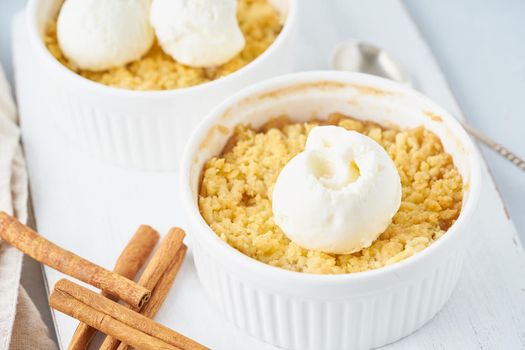 Apple crumble with streusel on light gray table, close up. Morning breakfast.