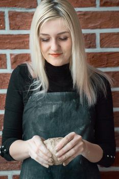 Smiling and happy woman making ceramic bowl in hand. Creative hobby concept. Earn extra money, side hustle, turning hobbies into cash, passion into a job, vertical