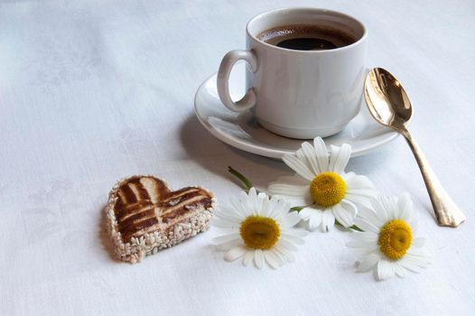 Cookies for the wedding with a cup of coffee served with a golden spoon. From the series "Wedding Cookies"