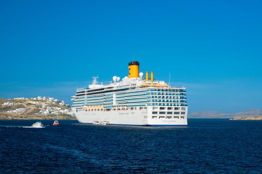 MYKONOS, GREECE - MAY 29, 2019: Cruise liner ship Costa Luminosa in Mediterranea sea near Mykonos island. Aegean sea, Greece