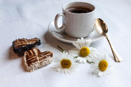 Cookies for the wedding with a cup of coffee served with a golden spoon. From the series "Wedding Cookies"