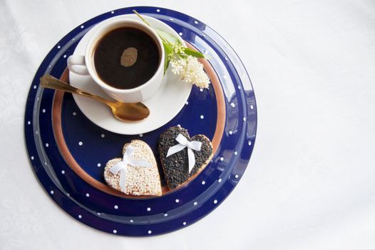 Cookies for the wedding with a cup of coffee served with a golden spoon. From the series "Wedding Cookies"