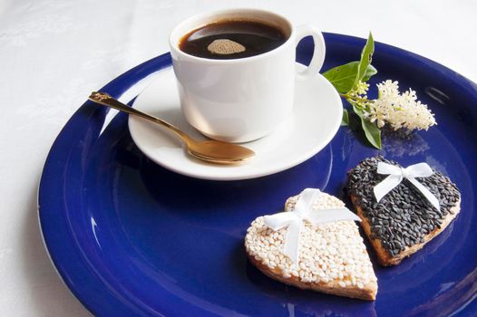 Cookies for the wedding with a cup of coffee served with a golden spoon. From the series "Wedding Cookies"