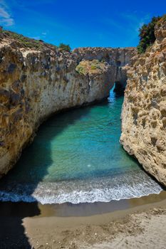 Papafragas hidden beach with crystal clear turquoise water and tunnel rock formations in Milos island, Greece