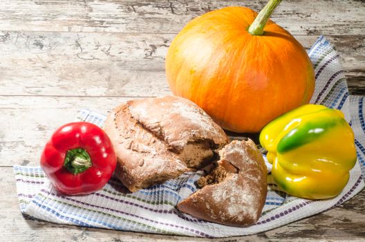 Bread and vegetables on old wooden table. From the series "Healthy Food"