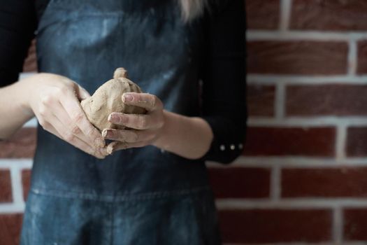 Unrecognisable woman making ceramic bowl in hand. Creative hobby concept. Earn extra money, side hustle, turning hobbies into cash, passion into a job, copy empty space