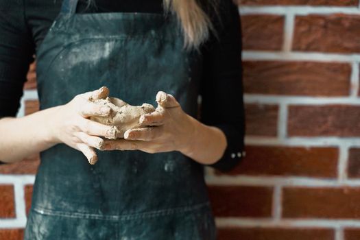 Unrecognisable woman making ceramic bowl in hand. Creative hobby concept. Earn extra money, side hustle, turning hobbies into cash, passion into a job, copy space