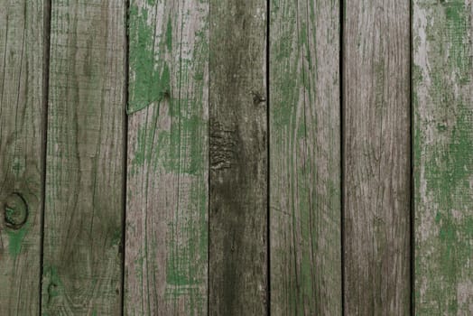 old shabby gray fence made of wooden boards. background texture wall