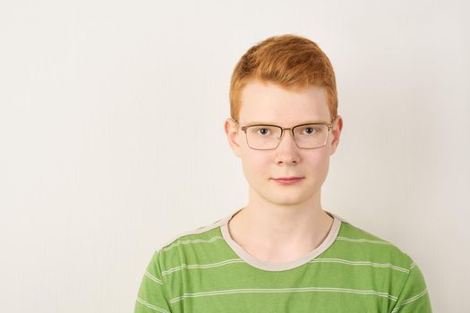shaven irish teenager wearing green t-shirt, ginger person portrait