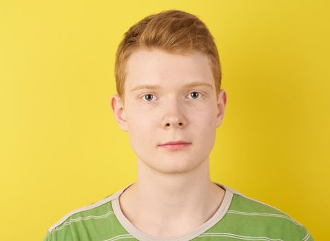 shaven young man, wearing green t-shirt, ginger person portrait closeup