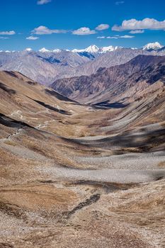 View of Karakorum range and road in valley from Kardung La - the highest motorable pass in the world (5602 m). Ladakh, India