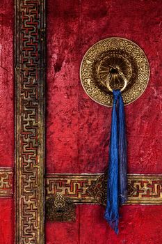 Gate of Spituk Gompa (Tibetan Buddhist monastery) with ornamented decorated door handle. Ladakh, India