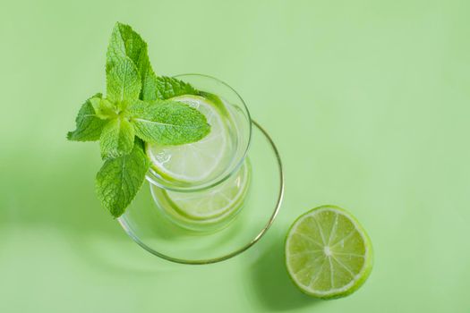 tea with mint and lime, with a calming effect, green still life close-up on a green background, top view. mojito, health drink, alternative medicine.High Quality Photo