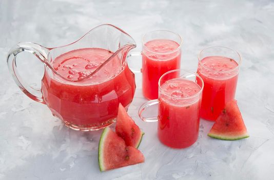 fresh red watermelon drink on hot summer day on light gray cement background. High quality photo