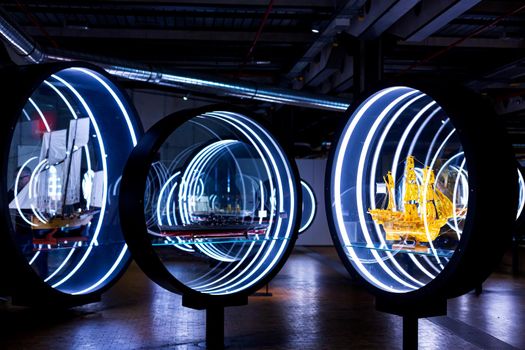 Art exhibition of ship models in glass circles in the museum.