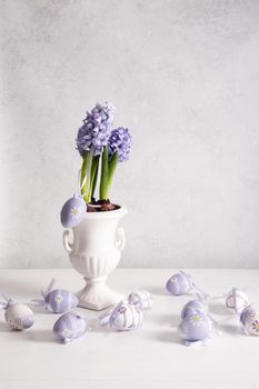 Easter eggs and Lilac hyacinth in a vase, spring still life, copy space. High quality photo