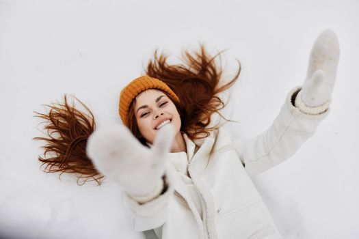 woman lies on the snow fun rest nature There is a lot of snow around. High quality photo