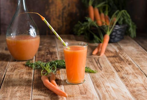 freshly squeezed carrot juice, and raw carrots, vegetarian vegetable vitamin drink, vintage still life concept, fresh carrot juice on wooden background, rustic still life