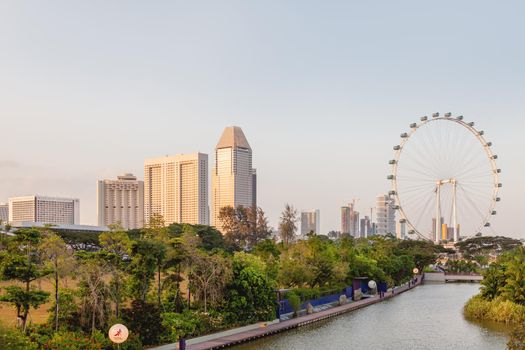 SINGAPORE, SINGAPORE - January 17, 2013. Aerial panorama view of Gardens by the Bay, Big Wheel attraction and business skyscrapers.