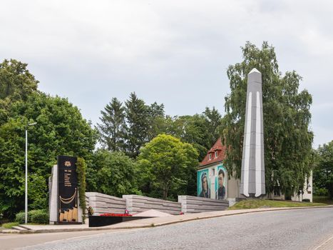 SVETLOGORSK, RUSSIA - July 21, 2019. Second World War memorial to war heroes. Monument and graffiti on house wall.