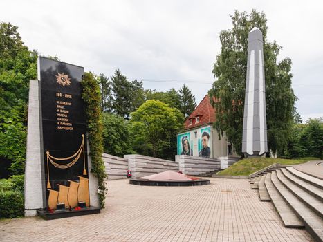 SVETLOGORSK, RUSSIA - July 21, 2019. Second World War memorial to war heroes. Monument and graffiti on house wall.
