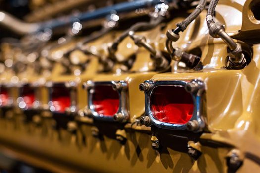 Close-up of a detail of a rare car engine. Metal mechanisms. Automotive industry.