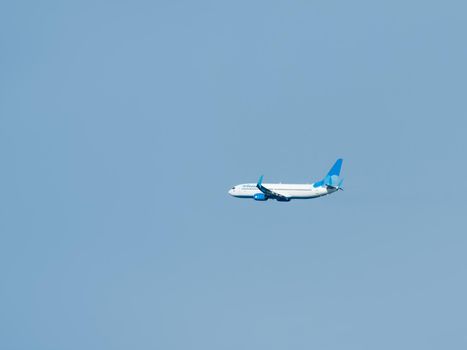 SOCHI, RUSSIA - September 21, 2021. Airplane of Pobeda air company is flying in clear blue sky. Aircraft in flight in good weather.