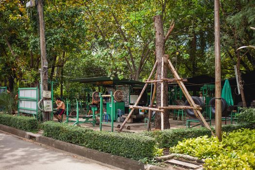 BANGKOK, THAILAND - October 23, 2012. Outdoor gym in Lumpini park. Exercise equipment made of old truck tires and metal bars.