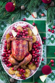 Christmas Chicken Baked with Potatoes and Cranberry Sauce, Christmas Dinner, Holiday Dinner, a step-by-step recipe for decorating a fried chicken, high quality photo