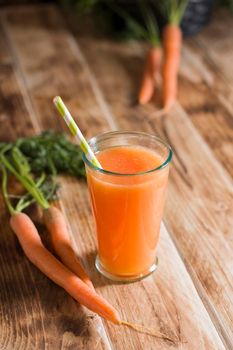 freshly squeezed carrot juice, and raw carrots, vegetarian vegetable vitamin drink, vintage still life concept, fresh carrot juice on wooden background, rustic still life